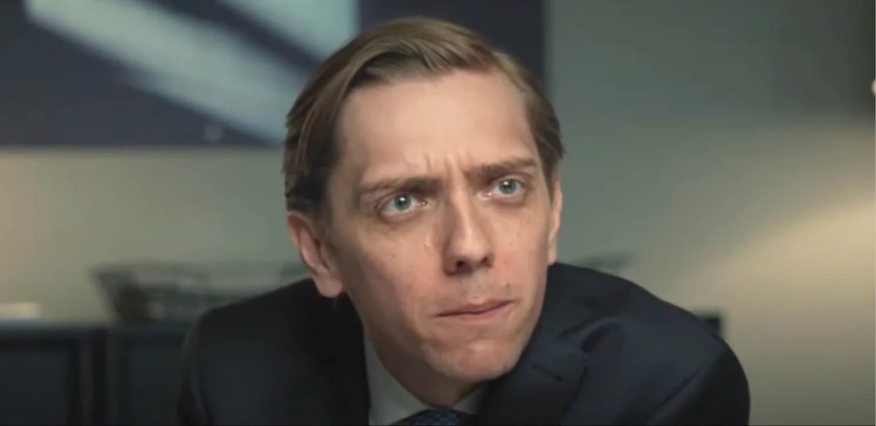 Reaction image: a man in a suit looking sceptical.